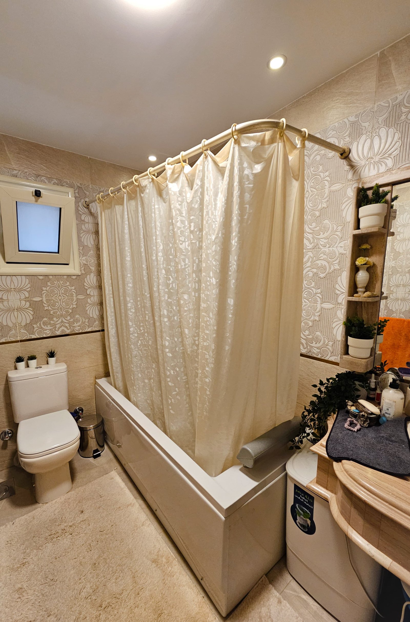 Cozy bathroom with shower curtain.